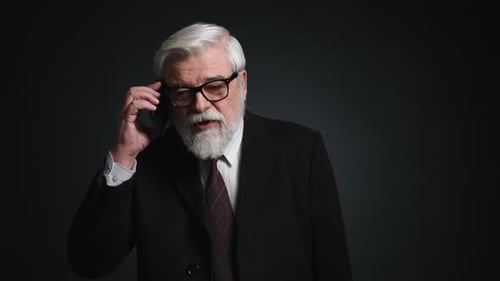 Portrait of Caucasian Adult Man Talking on the Telephone
