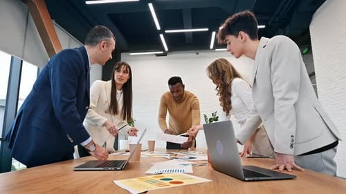 Multiracial group of people at business meeting in an office, discussing business affairs with each