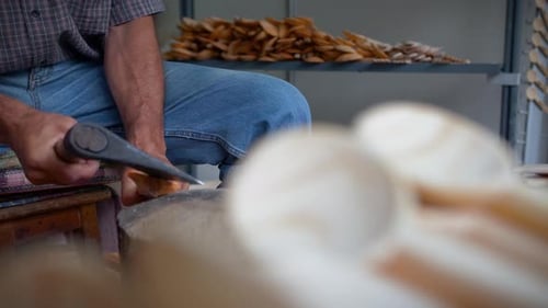 A unique craftsman making a handmade vintage wood spoon for cooking.
A cultural traditional old way