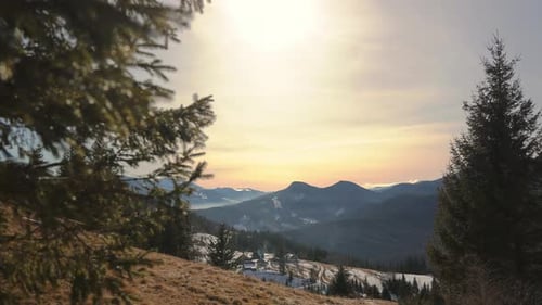 Golden Sunset Over Snowcovered Mountains Scenic Winter Landscape with Evergreen Trees Peaceful Sky