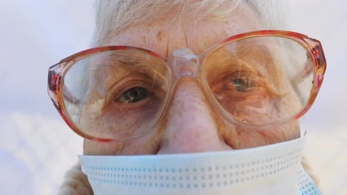 Close Up Face of Granny in Protective Mask From Virus Elderly Woman Looking Into Camera with Pensive