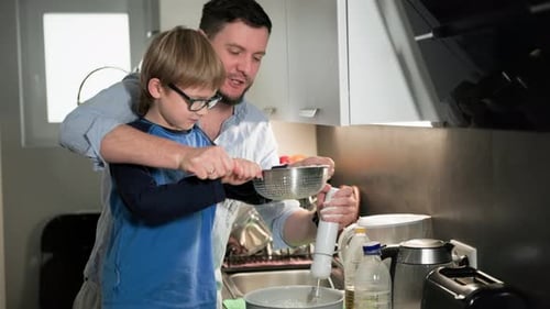 Father and Son Baking Together in Kitchen