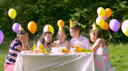 Children Celebrate at Outdoor Birthday Party in Sunlight