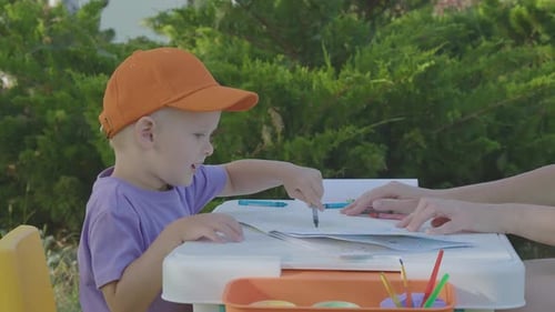Three Year Old Boy And His Mother Draw In Home Garden 3
