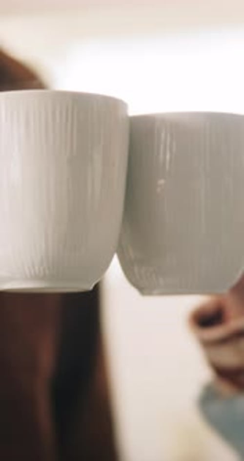 People Clink Mugs Together