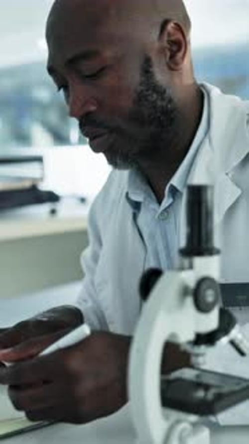 Writing, science and black man in lab, microscope for research and experiment for cure
