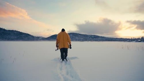 Man Walking On Deep Snowy Field In Indre Fosen, Norway - wide shot