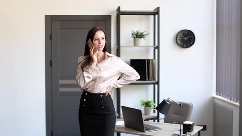 Businesswoman Talking on Phone in Modern Office