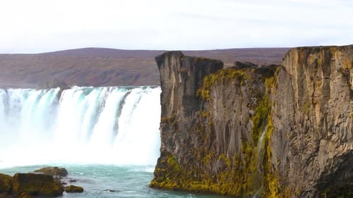 Slow establishing shot of the beautiful Godafoss waterfall flowing in Iceland