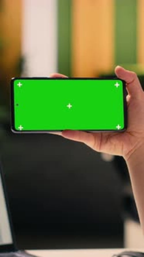 Vertical Video Chroma Key on Smartphone Held By Woman Worker in Corporate Environment