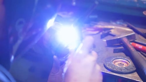 Welder Working on Metal Pipe in Bright Workplace