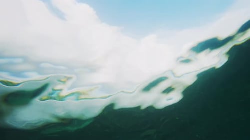 Underwater View of Ocean Waves and Sky