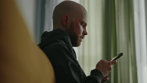 Adult Man Using Phone Indoors Close Up