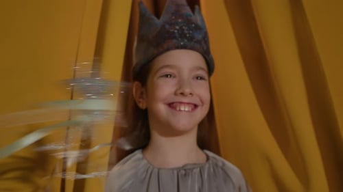 Happy Child Actress Smiles Behind Theater Curtains