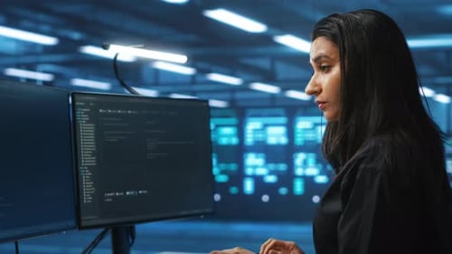 Woman Coding at Computer in a Futuristic Workplace