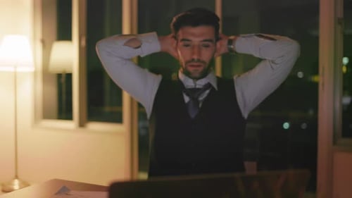 Caucasian businessman working on a laptop late night in the office