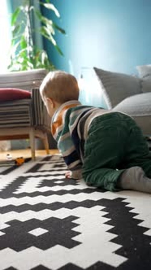 Vertical of Boy Craws on Floor in Living Room