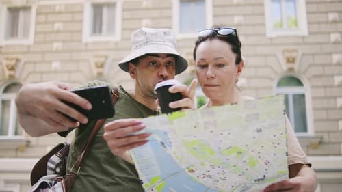 Lost Tourists Navigating with Map and Mobile Phone