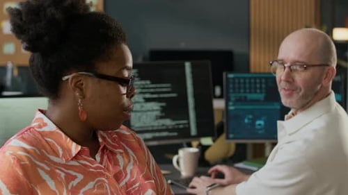 Diverse Programmers Discussing Work in Open Space Office