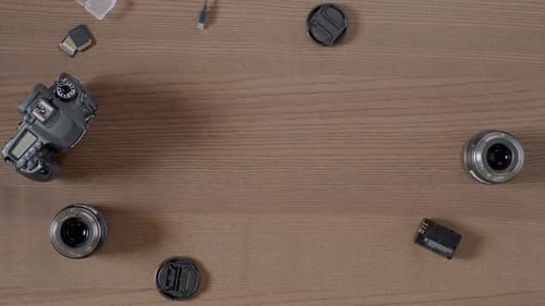 Camera Body Lenses and Accessories on Wooden Surface
