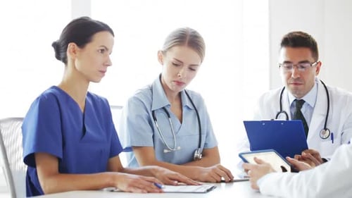 Doctors discussing medical concepts at hospital meeting