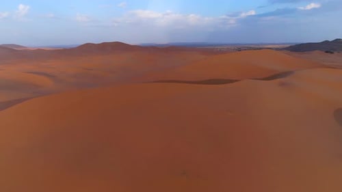 Cinematic aerial flyover endless Sand Dunes in Merzouga Desert,Morocco during sunny day
