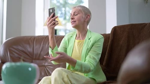 Woman with Gray Hair Talking on Phone Indoors