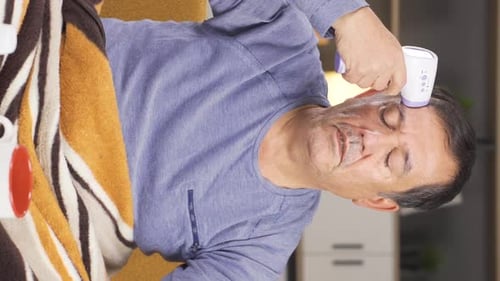 Adult Man Checking Temperature with Thermometer at Home