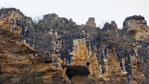 Dramatic Rocky Cliffs with Cave Openings