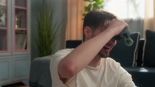 Man Taking a Break After Exercise at Home
