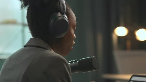 Young Woman Speaking into Microphone for Broadcast