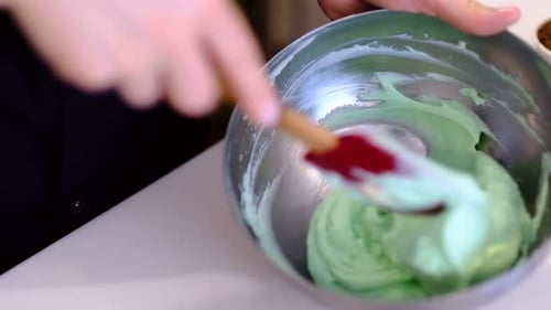 Mixing Green Buttercream Frosting in Bowl