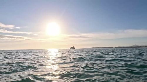 Waves Gently Rolling Toward Shore at Sunset