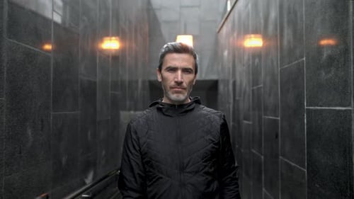 Portrait of Focused European Runner at Cold Weather Young Sportsman Wearing Hat and Hooded Zipper