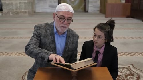 Man and Child Read Religious Book Together