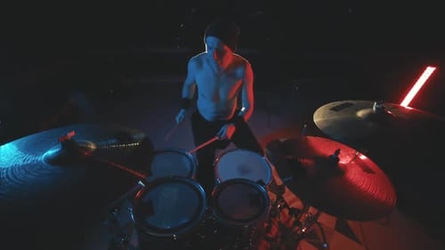 Shirtless Rock Drummer Playing Drums Energetically
