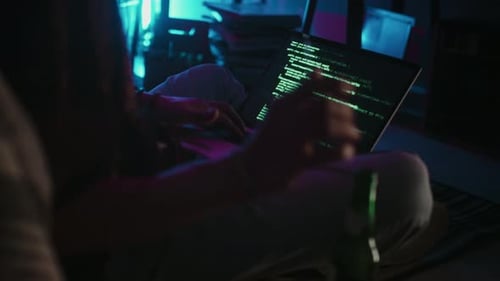 Young Adult Typing Code at Night