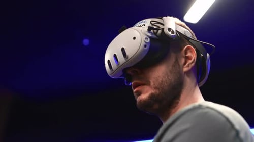 Man Wearing Virtual Reality Headset in Dark Room