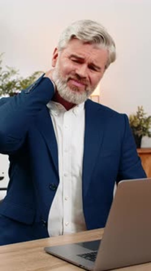 Man Working on Laptop with Neck Pain