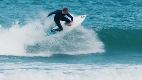Surfer Rides the Wave in the Ocean