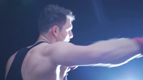 The fighter trains his fists in the boxing gym. Boxing Training.