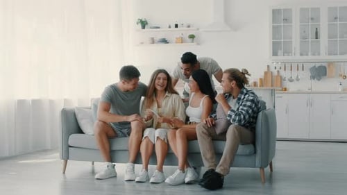 Friends Celebrate Happy Announcement on Sofa