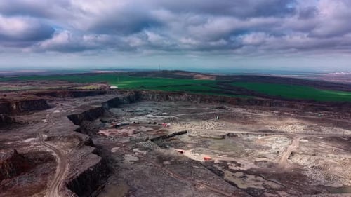 View of industrial granite quarry activity in open landscape