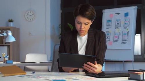 Woman uses Tablet with App Designs in Office