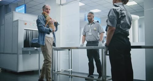 Airport Terminal Mature Man with Chihuahua at Security Checkpoint