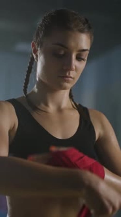 Woman Fighter Wraps Her Hands with Boxing Bandages Boxing Training in a Gym Ready for Battle Woman