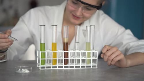 Teenage Girl Scientist Doing Lab Test with Chemicals Alone