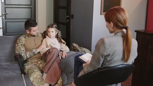 Father and Child Talking with Therapist in Home