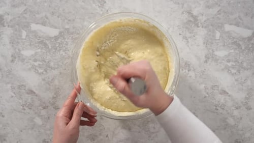 Time Lapse Mixing Ingredients in a Glass Mixing Bowl to Prepare Coconut Banana Pancakes