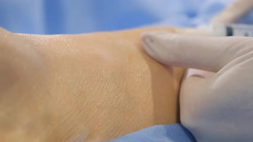 Medical Professional Giving Injection to Patient's Arm